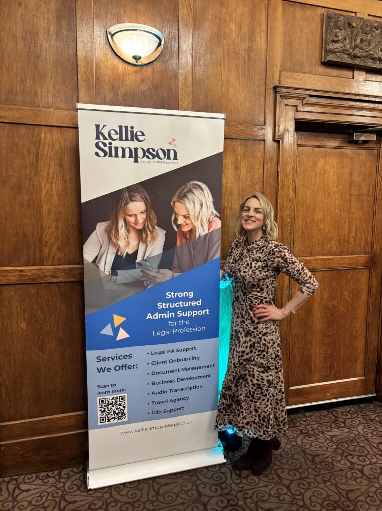 Kellie at Adviserly event in dress with her banner