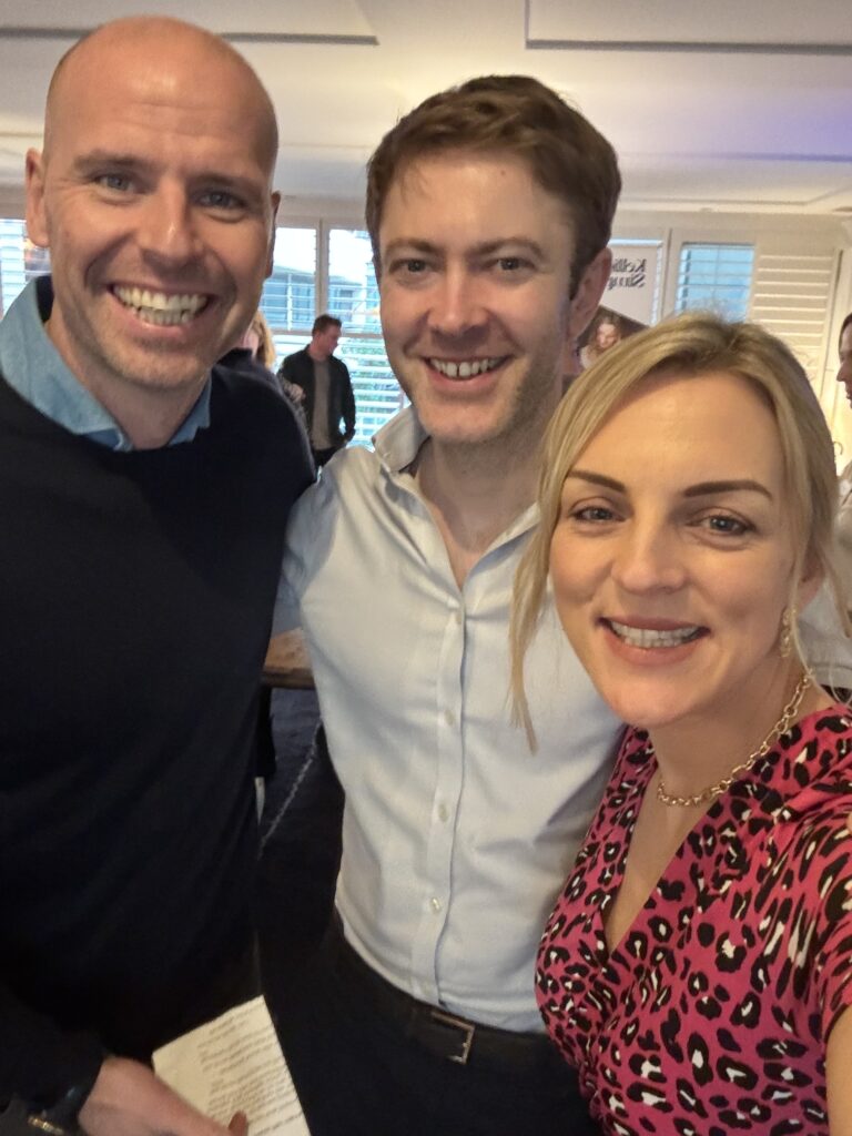 Kellie taking a group photo at Adviserly event with Bill and Rob