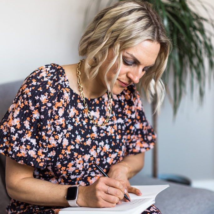 Kellie writing in a notebook