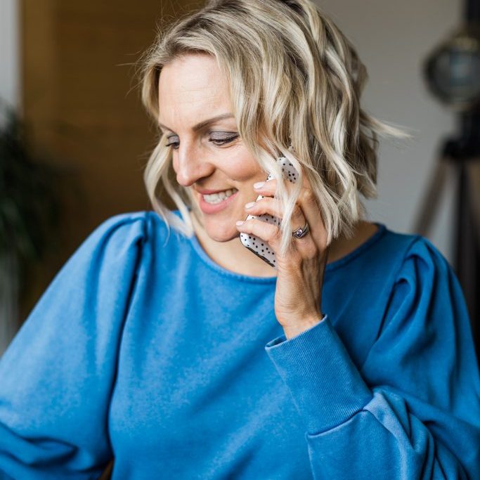 Kellie in blue on phone