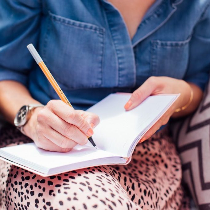 Kellie Meal Planning in a notebook