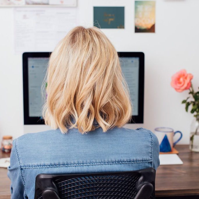 Girl at computer working on Asana