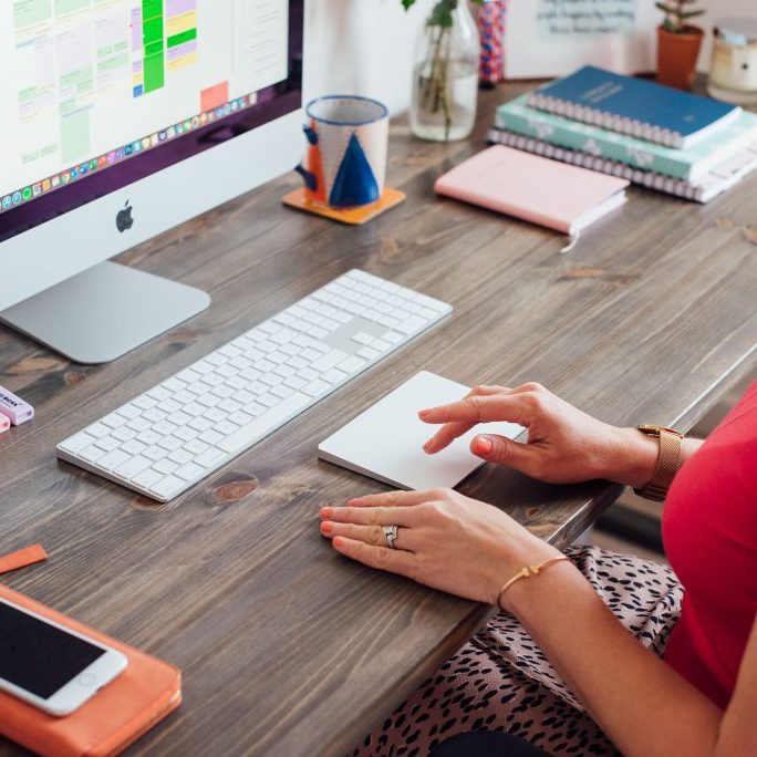 girl sat at computer using tracker pad