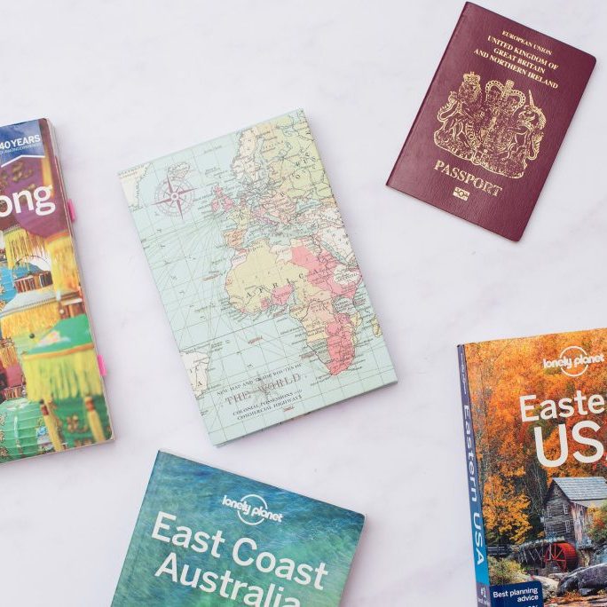 Travel books, passport and map ready for a business trip.