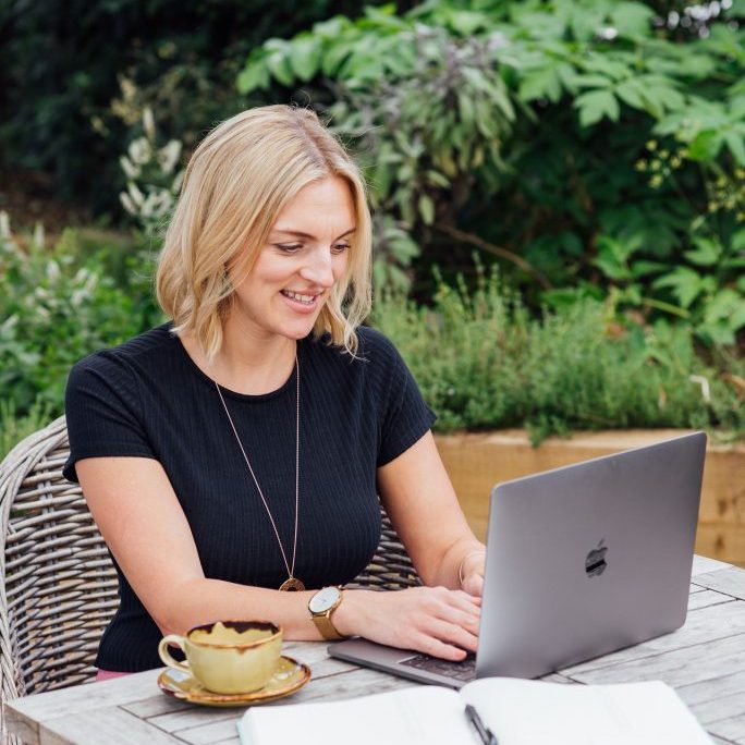 Kellie on lap top working virtually