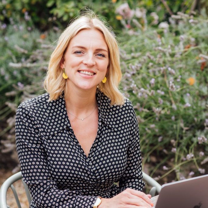 Kellie on laptop using Asana