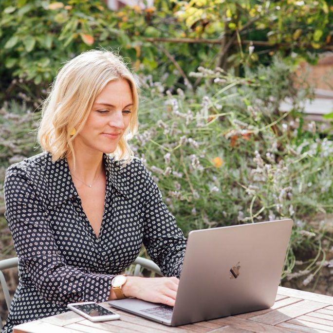Woman sat at table on laptop