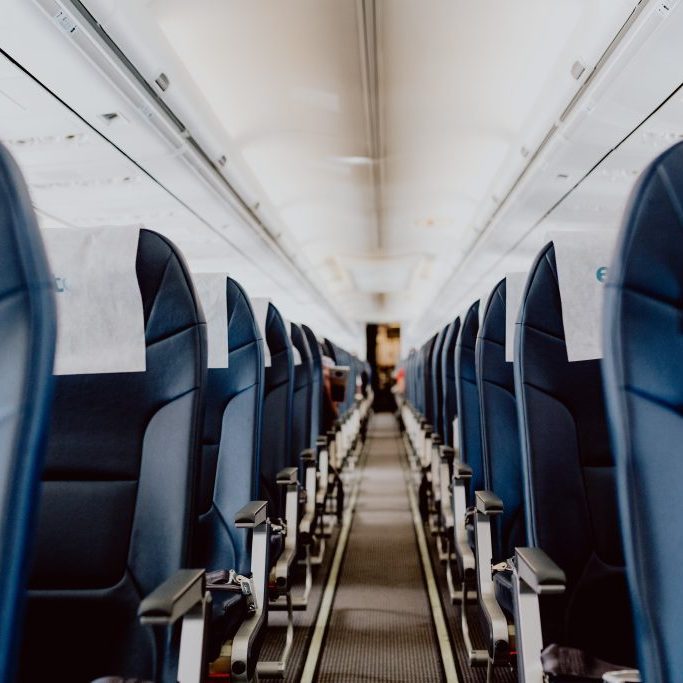 Empty airplane seats in teh cabin